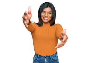 Young latin transsexual transgender woman wearing casual clothes looking at the camera smiling with open arms for hug. cheerful expression embracing happiness.