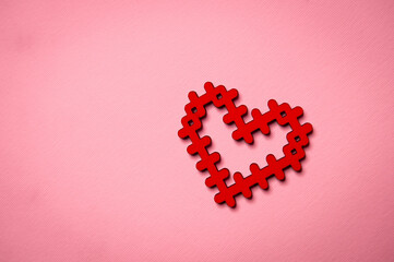 Valentine's Day. The heart lies on a pink surface. Heart on a pink background. Love symbol. Love. 