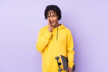 Handsome young skater man over isolated wall whispering something