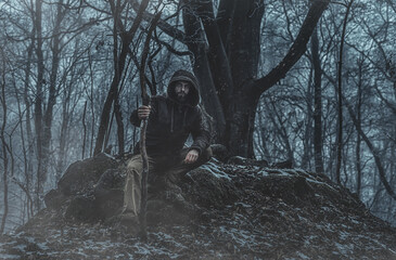 Shamanic man in the nature, winter landscape.