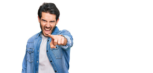 Fototapeta premium Young hispanic man wearing casual clothes pointing displeased and frustrated to the camera, angry and furious with you