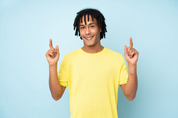 Young african american man isolated on blue background pointing up a great idea