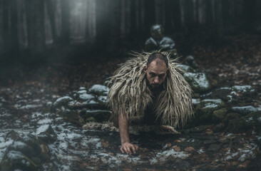 Shamanic man in the nature, winter landscape.