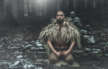 Shamanic man in the nature, winter landscape.