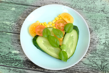 Healthy salad simple ingredients with vegetables in heart shape. tomatoes, cucumbers, basil, corn. fibre antioxidants, minerals and vitamins. Shallow DOF. Selective focus Very light breakfast concept