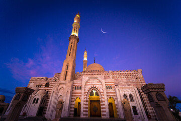 Beautiful large Islamic mosque at the sunset sky background
