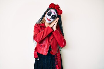 Fototapeta premium Woman wearing day of the dead costume over white sleeping tired dreaming and posing with hands together while smiling with closed eyes.