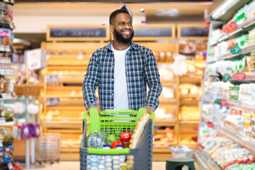 Black Guy Buying Food In Supermarket During Grocery Shopping