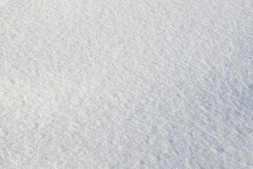 White snow texture on clear day. Winter background. Snow drifts. white snowflakes background, rough pattern of snow texture