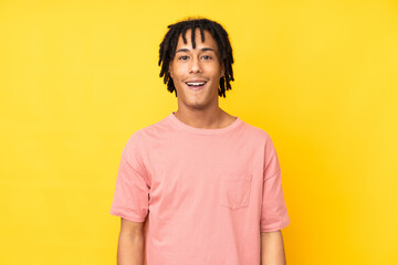 Young african american man isolated on yellow background with surprise facial expression