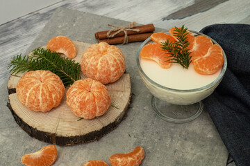 Dessert with cottage cheese and tangerines in a glass bowl