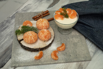 Dessert with cottage cheese and tangerines in a glass bowl
