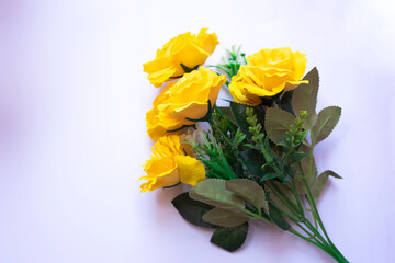 Yellow roses with green leaves in a bright beautiful bouquet on white background
