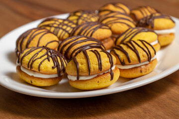 Desserts filled and covered with chocolate glaze. Bouchée.