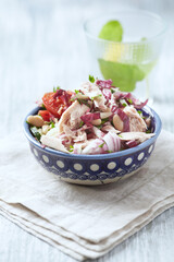 Salad with tuna, tomatoes and cucumber. Wooden background. Close up.