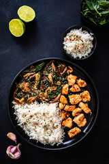Chicken nuggets with white rice and oyster mushrooms  on wooden table