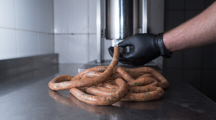 The chef makes minced pork sausages. Natural food in a pub