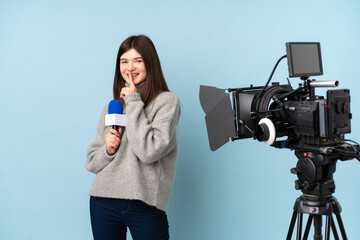 Young reporter woman holding a microphone and reporting news doing silence gesture