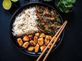 Chicken nuggets with white rice and oyster mushrooms  on wooden table