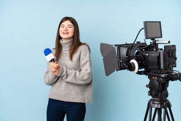 Young reporter woman holding a microphone and reporting news applauding