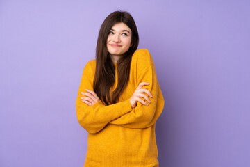 Fototapeta premium Young Ukrainian teenager girl over isolated purple background making doubts gesture while lifting the shoulders