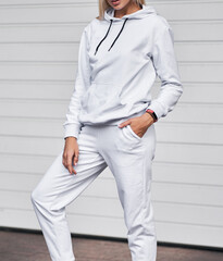 Young girl wears white fleece hoodie. Mockup for clothing line design and logo placement