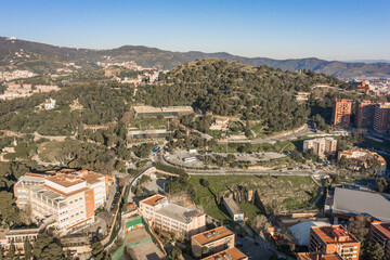 Fototapeta na wymiar Aerial drone shot of park guell hill in Barcelona in morning