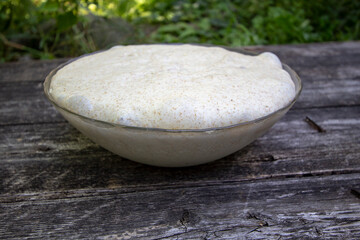 yeast dough for bread in a glass bowl