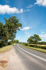 Naklejka premium Summertime road in the countryside