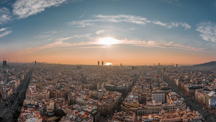 Aerial drone shot of Barcelona center with beach sunrise