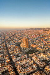 Aerial drone shot of Barcelona city before sunrise golden hour