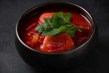 Hot red beet Kubbeh soup, a famous middle eastern dumplings soup dish, served in a bowl. A Jewish-Iraqi traditional matfuniya winter soup. Levantine dish made of bulgur, minced onions, ground  beef