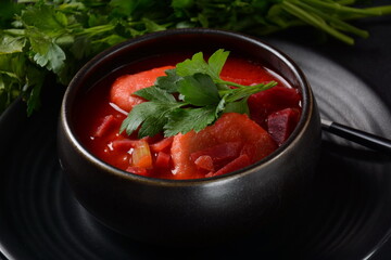 Hot red beet Kubbeh soup, a famous middle eastern dumplings soup dish, served in a bowl. A Jewish-Iraqi traditional matfuniya winter soup. Levantine dish made of bulgur, minced onions, ground  beef