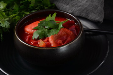 Hot red beet Kubbeh soup, a famous middle eastern dumplings soup dish, served in a bowl. A Jewish-Iraqi traditional matfuniya winter soup. Levantine dish made of bulgur, minced onions, ground  beef