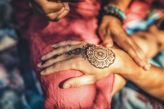 Henna art on woman's hand.