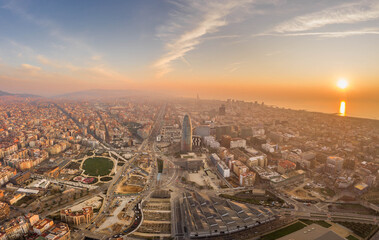 Aerial drone shot of agbar tower by Barcelona beach with sunrise - obrazy, fototapety, plakaty