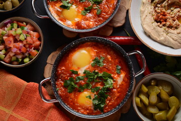 Shakshouka, eggs poached in sauce of tomatoes, olive oil, peppers, onion and garlic, Mediterranean cuisine
