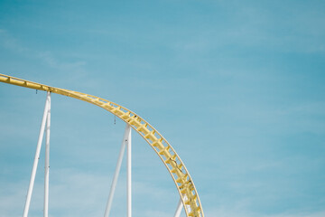 detail view of roller coaster against blue sky