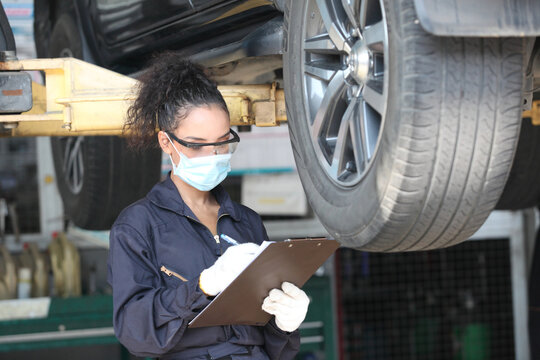 Two Car Mechanic On Protective Mask Anti Coronavirus Or Covid19 ,  They Are Fixing  And Service Maintenance Of Industrial To Engine Repair, For Transport Automobile Automotive