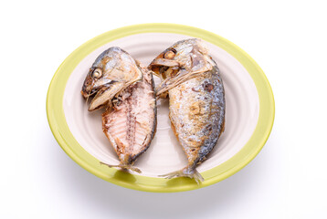 Delicious fried mackerel in a plate on a white background - top view