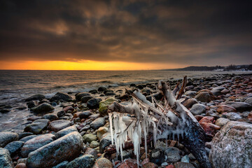 Amazing landscape of frozen rocks on the beach in Gdynia Orlowo at sunrise. Poland