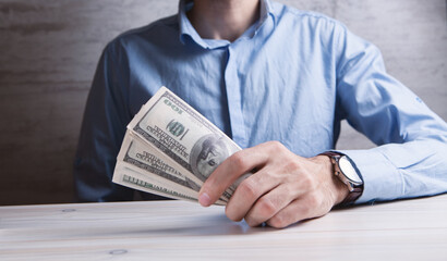 man counts money calculating finance