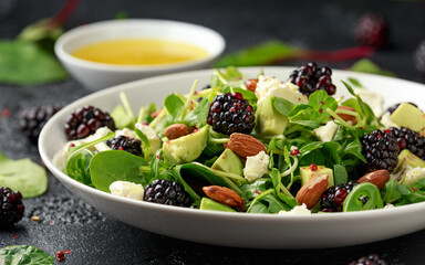 Blackberry salad with greens, almond nuts, feta, avocado and feta cheese