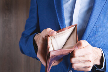 young man holding empty wallet
