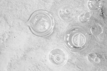 Antique laboratory glassware flat lay on granite surface black and white with negative space for copy