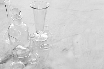 Antique laboratory glassware on granite surface black and white with negative space for copy