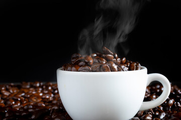 Hot roasted coffee beans in a white coffee cup
