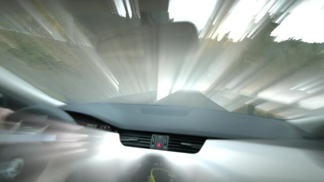 Driving on the iridescent rays of light - abstract vision from inside the car of person driving on a tiny rural highway in mountains with multiple serpentines 
