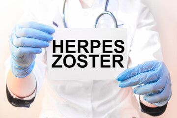 The doctor's blue - gloved hands show the word HERPES ZOSTER - . a gloved hand on a white background. Medical concept. the medicine