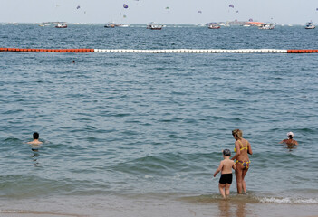 Pattaya Beach. Woman with a child goes into the water